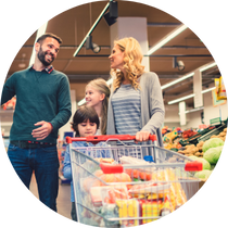 a happy family shopping for groceries together at the supermarket